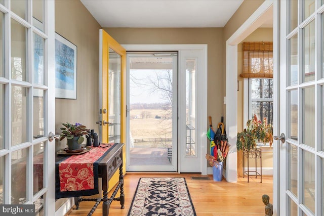 entryway featuring plenty of natural light, french doors, visible vents, and wood finished floors