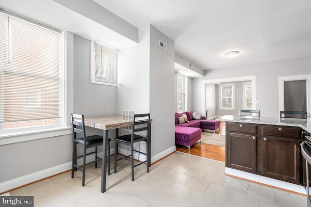 dining space featuring baseboards and visible vents