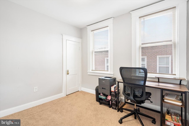 office with plenty of natural light, baseboards, and carpet