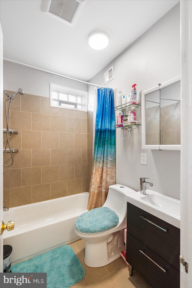 bathroom featuring vanity, toilet, tile patterned floors, visible vents, and shower / bath combo