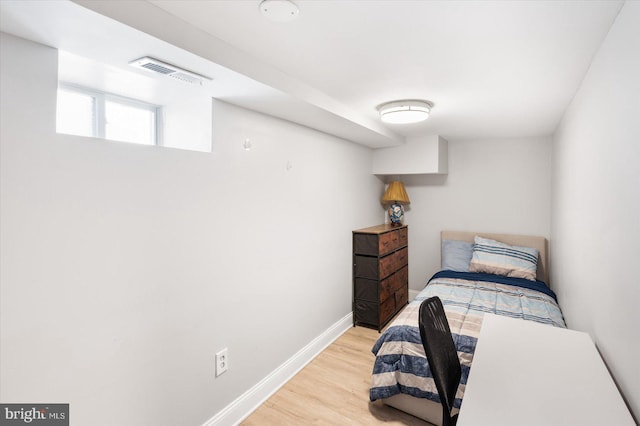 bedroom with baseboards, visible vents, and light wood-style flooring