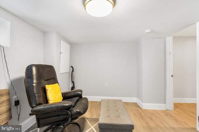 living area with baseboards and light wood-type flooring