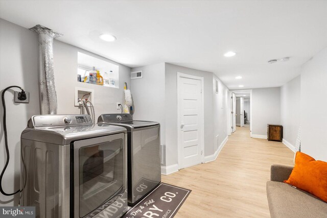 laundry room with baseboards, laundry area, recessed lighting, light wood-type flooring, and separate washer and dryer