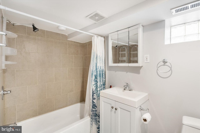 full bathroom featuring shower / bathtub combination with curtain, visible vents, toilet, and vanity