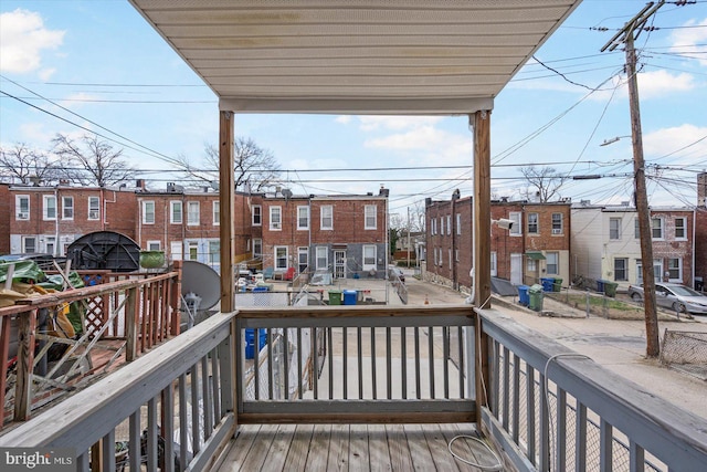 wooden terrace featuring a residential view