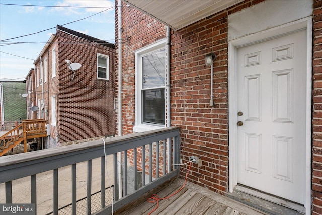view of exterior entry with brick siding