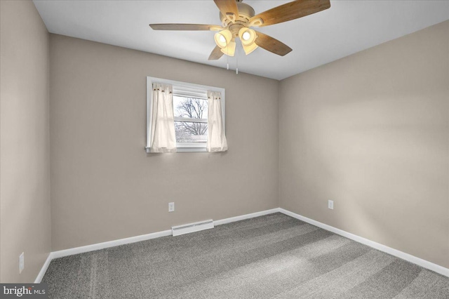 carpeted empty room featuring visible vents, baseboards, and ceiling fan