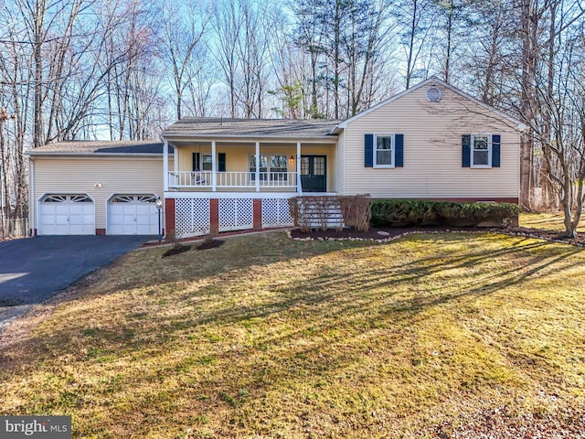 view of front of property with aphalt driveway, a garage, covered porch, and a front yard