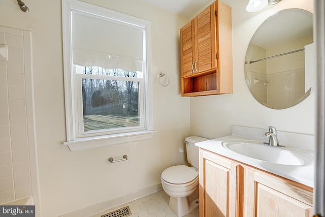 bathroom featuring visible vents, toilet, a shower, baseboards, and vanity