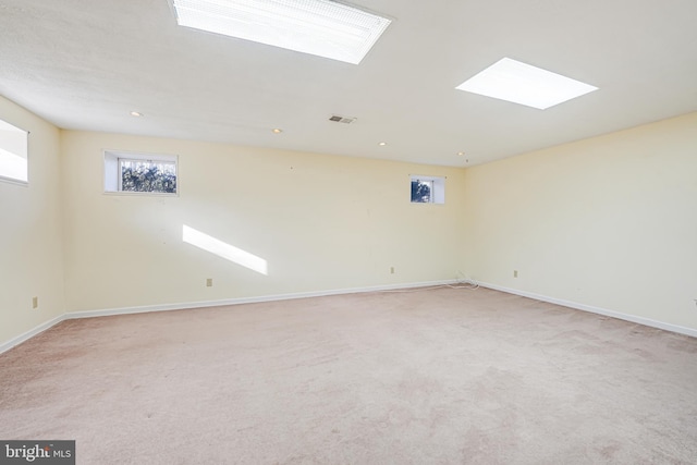 empty room with recessed lighting, baseboards, visible vents, and light carpet