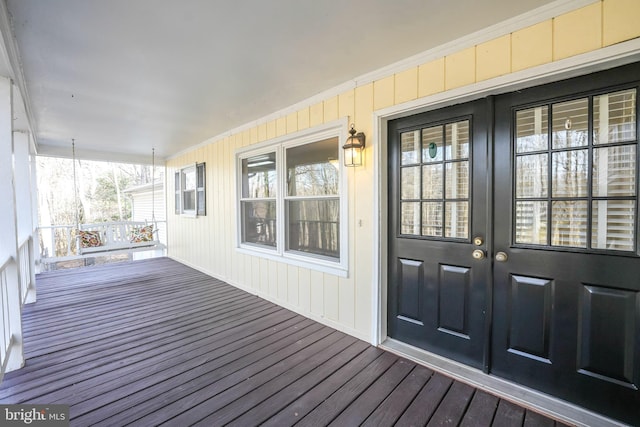 doorway to property with covered porch and french doors