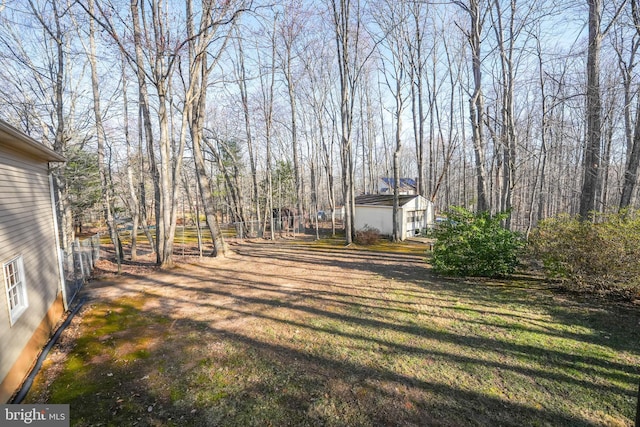 view of yard with an outbuilding and fence