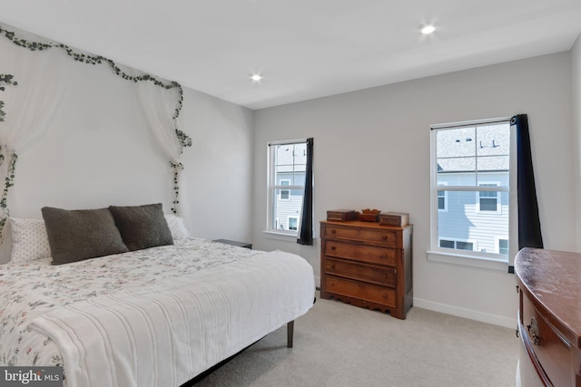 bedroom featuring recessed lighting, baseboards, and light carpet