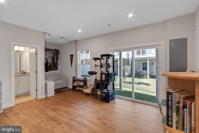 misc room with visible vents, baseboards, electric panel, recessed lighting, and light wood-style floors