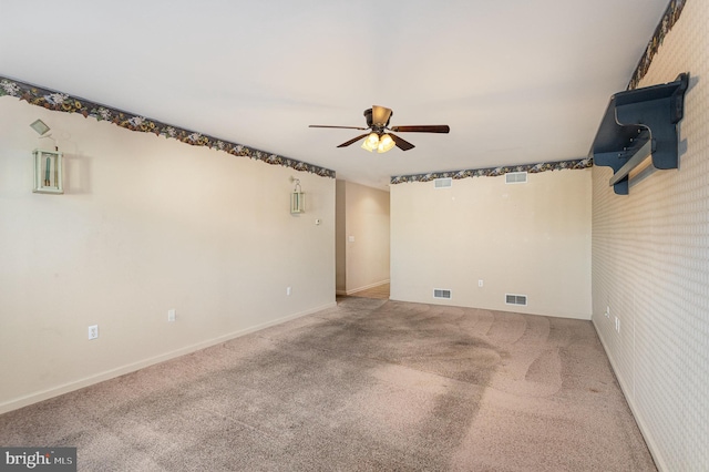 spare room with visible vents, ceiling fan, and carpet flooring