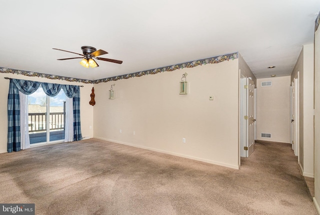 spare room with visible vents, baseboards, and light colored carpet