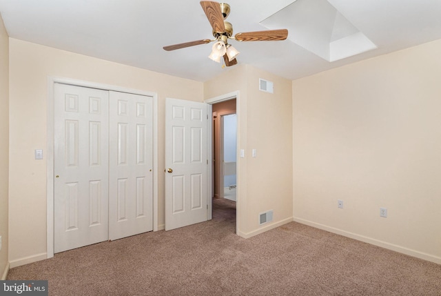 unfurnished bedroom featuring a closet, visible vents, baseboards, and carpet floors