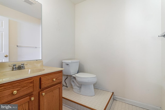 bathroom with tile patterned floors, visible vents, toilet, baseboards, and vanity