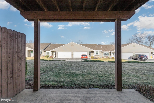 view of yard with a residential view and an attached garage