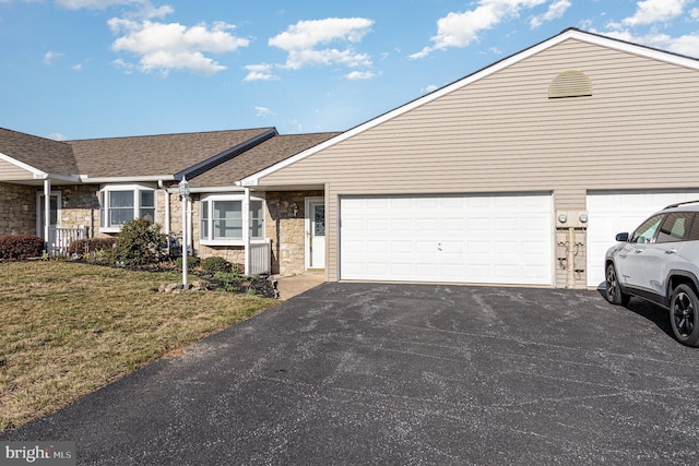 single story home featuring driveway, stone siding, roof with shingles, a front yard, and a garage