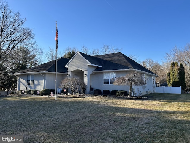 single story home with a front lawn and fence