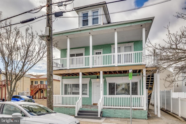 view of property featuring stucco siding and a porch