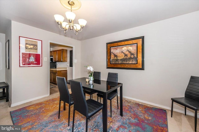 1900 Lyttonsville Rd Unit 418, Silver Spring, MD 20910 - dining area with baseboards, a notable chandelier, and light carpet