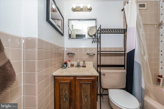 1900 Lyttonsville Rd Unit 418, Silver Spring, MD 20910 - bathroom featuring vanity, toilet, tile walls, and shower / tub combo
