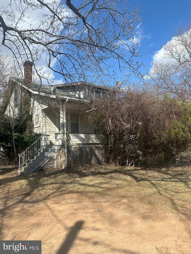 view of side of home featuring a chimney