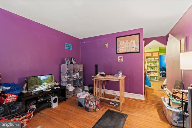 home office featuring baseboards and wood finished floors