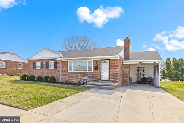 ranch-style house with brick siding, concrete driveway, a chimney, and a front lawn