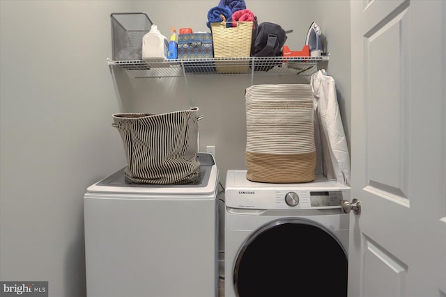 clothes washing area with laundry area and separate washer and dryer