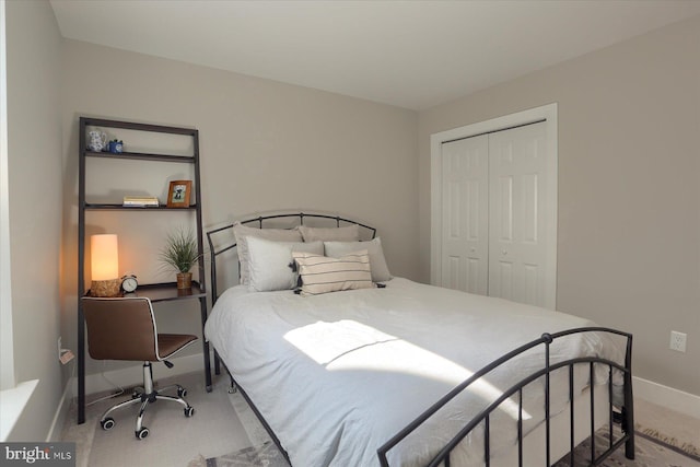 bedroom featuring a closet, carpet floors, and baseboards