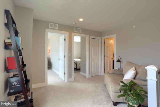 sitting room with recessed lighting, visible vents, light carpet, and baseboards