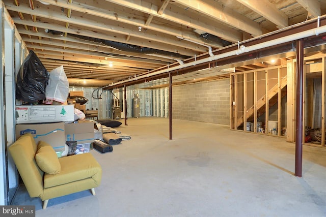 unfinished basement featuring heating unit and water heater