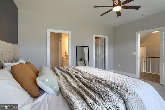 bedroom with connected bathroom, baseboards, and a ceiling fan