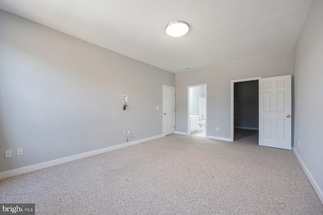 unfurnished room with light colored carpet and baseboards