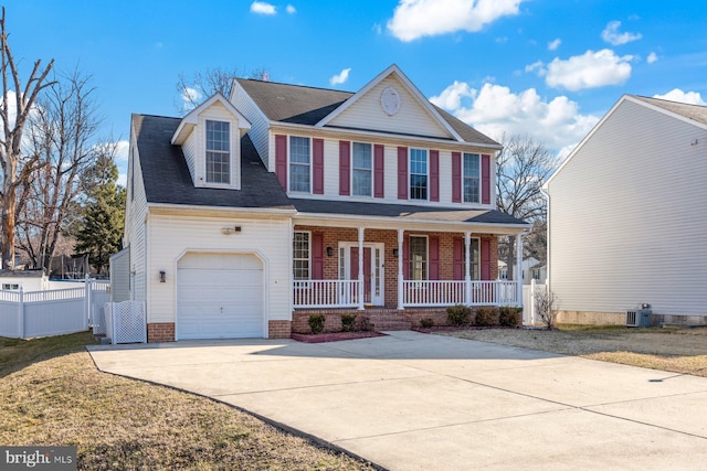 view of front of house with central AC unit, fence, a porch, concrete driveway, and a garage