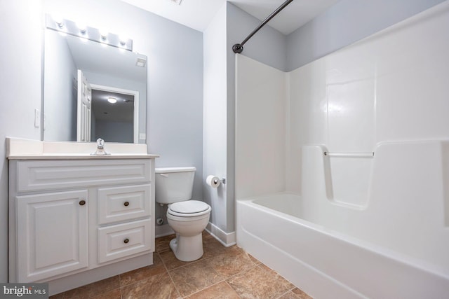 full bath with vanity,  shower combination, toilet, and baseboards