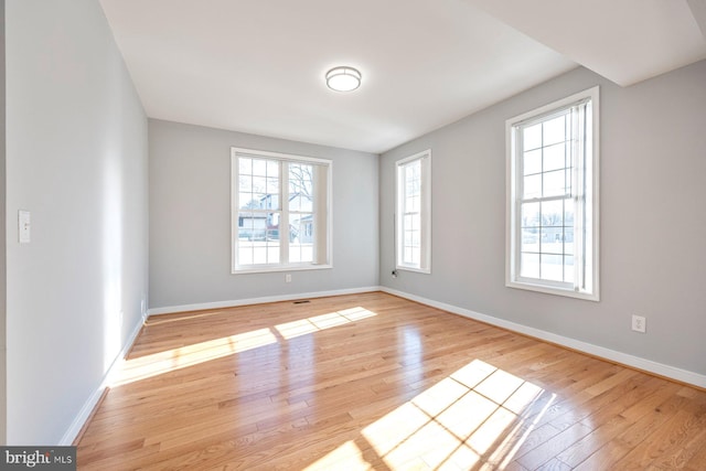 unfurnished room featuring light wood-style floors and baseboards