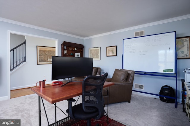 carpeted office space featuring visible vents, baseboards, and crown molding