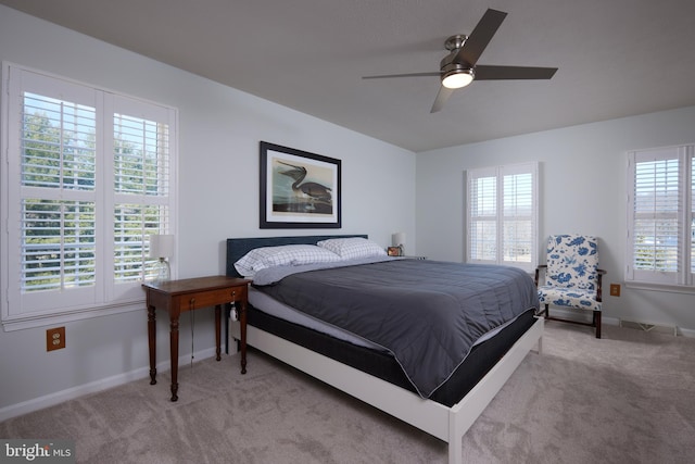 carpeted bedroom featuring ceiling fan and baseboards