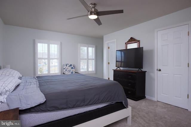 bedroom featuring light carpet, baseboards, and ceiling fan