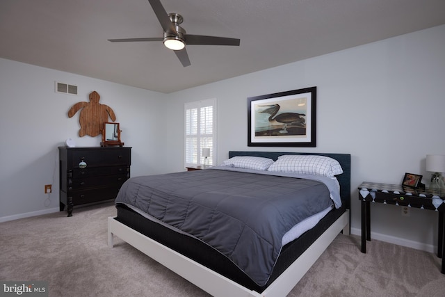 bedroom featuring a ceiling fan, light colored carpet, visible vents, and baseboards