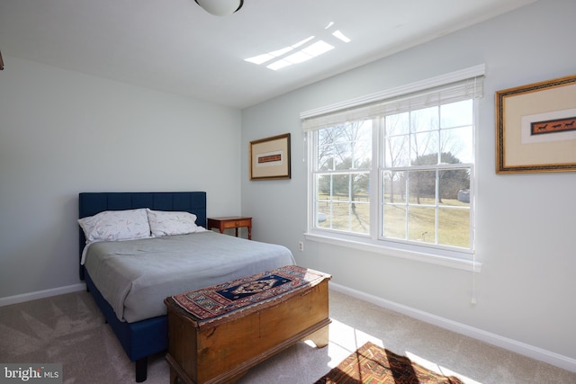 bedroom with baseboards, multiple windows, and carpet flooring