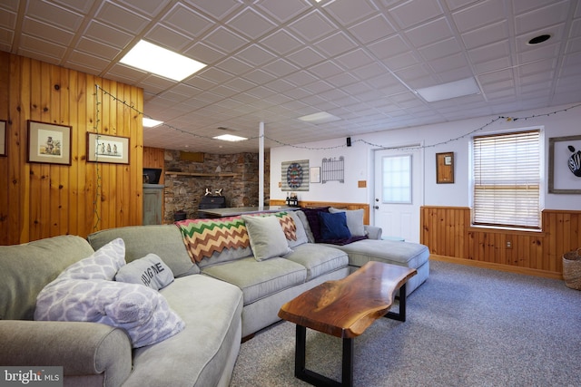 living room with a wainscoted wall, wood walls, and carpet