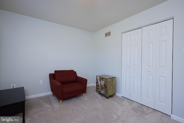 living area with carpet flooring, baseboards, and visible vents