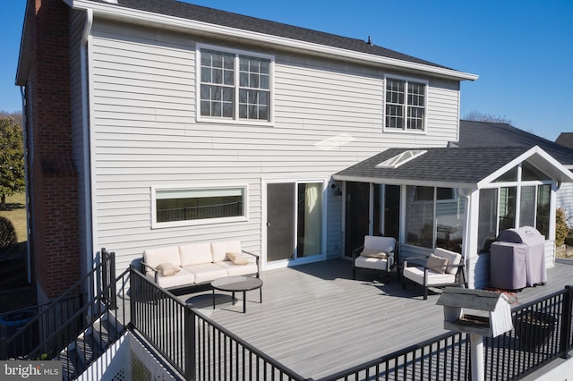 back of house featuring a deck, an outdoor living space, a shingled roof, brick siding, and a chimney