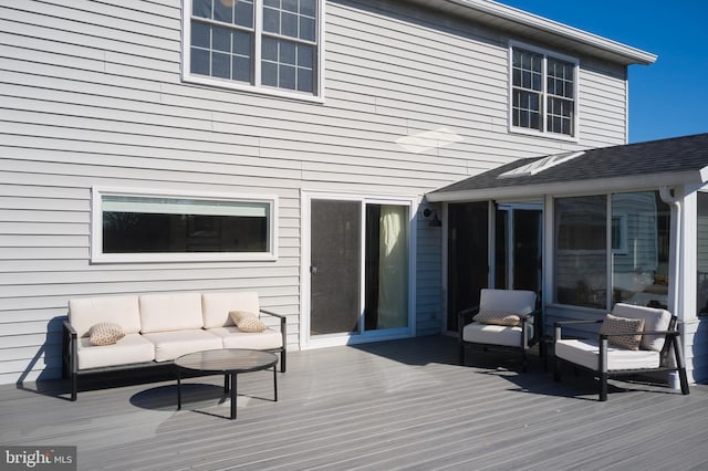 deck with outdoor lounge area and a sunroom