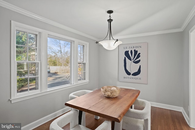 dining space with baseboards, ornamental molding, and dark wood-style flooring